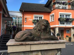 a statue of a lion in front of a building at PENSION JÄGER - der Geheimtipp am Europa-Park in Rust