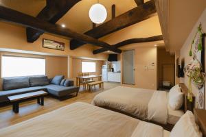 a large room with two beds and a couch at 楚々Soso in Miyazu