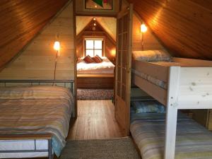 a bedroom with two bunk beds in a cabin at Cedar Boathouse Overlookng Baltimore, West Cork & Islands in Baltimore