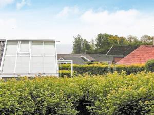a house with a window in a field of flowers at 4 star holiday home in Sydals in Sarup