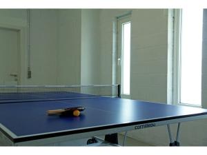 a ping pong table with a ball on top of it at Durbuy Villa with Sauna in Durbuy