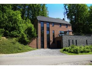 a brick building with its door open on a road at Durbuy Villa with Sauna in Durbuy +33 photos