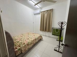 a bedroom with a bed and a tv in it at MITC Comfort Stay in Malacca