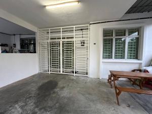 a living room with white walls and a wooden table at MITC Comfort Stay in Malacca