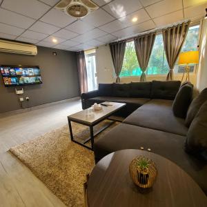 a living room with a couch and a table at Private Suite with Private Entrance - Self Check in - F-8 - Private Parking in Islamabad