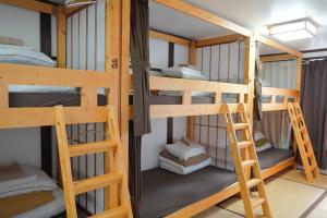 a room with bunk beds in a hostel at Sansan Yuzawa Backpackers in Yuzawa