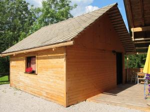 a large wooden dog house with a roof at Apartment Zalokar in Bohinj