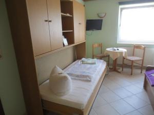 a hospital room with a bed with a pillow on it at Pension Barghus GmbH in Zinnowitz