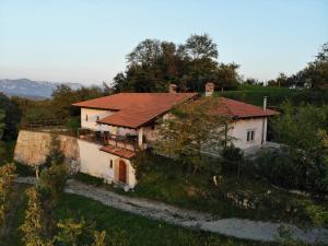 a white house with a red roof on a hill at Karol-ina Estate in Branik