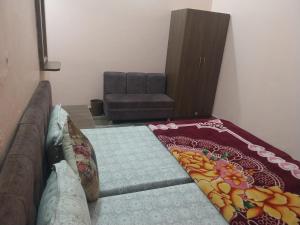 a living room with a couch and a chair at hotel vikram khajuraho in Khajurāho
