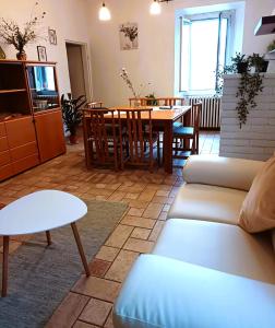 a living room with a couch and a table at Julian byb in Cassano Spinola +13 photos