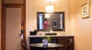 a room with a table and a mirror and a sink at Hotel Normandie Los Angeles in Los Angeles +211 photos