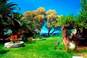 A garden outside Kalives Apartments
