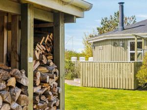 a pile of fire wood next to a house at 4 person holiday home in Vinderup-By Traum in Vinderup