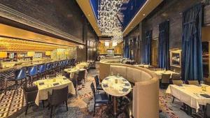 a restaurant with tables and chairs in a room at Disney's Boardwalk Inn in Orlando
