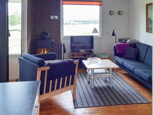 a living room with blue couches and a table at 10 person holiday home in Højslev-By Traum in Lund