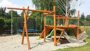 a wooden playground with a swing at Penzion Na Lednické in Hlohovec
