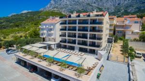 an aerial view of a hotel with a mountain in the background at Luxury Aparthotel in Makarska