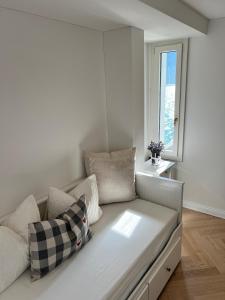 a white couch in a room with a window at Exclusive Lake Access Villa Studio in Fluelen +13 photos