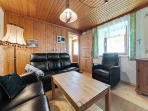 a living room with leather furniture and a wooden ceiling at Chalet in Eberstein nahe Saualpe Skigebiet in Eberstein +30 photos