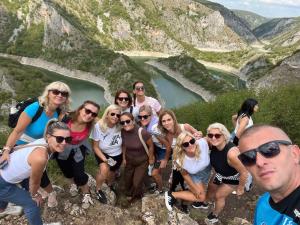 a group of people standing on the side of a mountain at Vila Helena -Apartman 3 in Nova Varoš