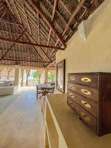 a room with a chest of drawers and a table at La Joya Lamu in Shela +43 photos