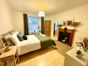 a bedroom with a large bed and a fireplace at Cosy Flat in Heart of Edinburgh in Edinburgh