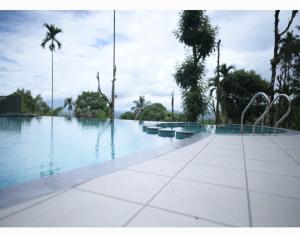 a swimming pool with statues in the middle of it at Chembra Adobe in Kalpetta