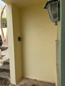 a corner of a wall with a light on it at Cascais - Villa at Guincho Beach in Charneca