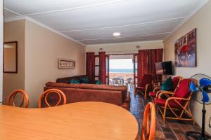 a living room with a couch and a table and chairs at Natspat 14 in Margate