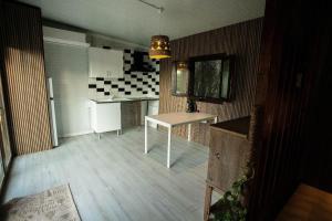 a kitchen with a table in the middle of it at Casita Verbena Retreat in Novo Sancti Petri