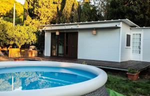 a swimming pool in front of a house at Casita Verbena Retreat in Novo Sancti Petri