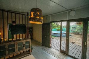 a living room with a view of a pool at Casita Verbena Retreat in Novo Sancti Petri