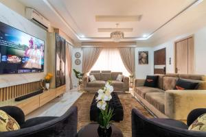a living room with a large flat screen tv at 3 Bedroom Duplex for Shortlet in Ikota