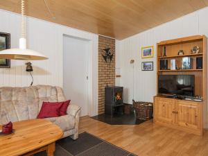 a living room with a couch and a television at 6 person holiday home in Toftlund in Toftlund +15 photos