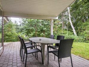 a table and chairs sitting on a patio at 8 person holiday home in Børkop in Børkop