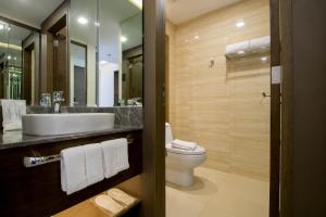 a bathroom with a sink and a toilet at Boracay Haven Suites in Boracay