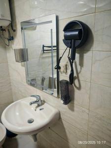 a bathroom with a sink and a phone on the wall at EVANNA SUITE AND HOTELs ايفانا للشقق الفندقيه و المفروشه in Amman +25 photos