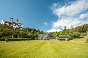 a large grass field in front of a house at Loch View House in Kilfinan