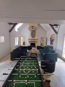 a living room with a pool table in the middle at La Ballière, un havre de douceur et de prestige in Coullons