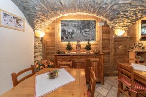 a dining room with a wooden table in a cabin at Chalet Chez Nous in Sauze dʼOulx