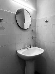 a bathroom with a white sink and a mirror at Rock Hill Hotel in Galle