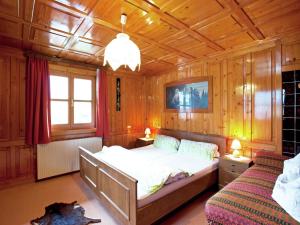 a bedroom with a bed and a couch in it at Apartment in Tschagguns near Ski Slopes in Tschagguns