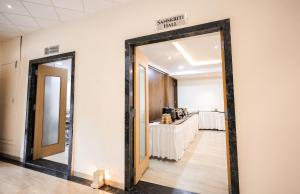 a mirror on a wall in a room at Hotel Konark - Vijay Nagar in Indore