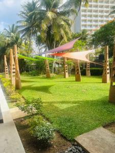 a park with trees and a net in the grass at Rock Hill Hotel in Galle