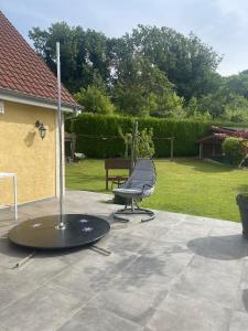 a ping pong table and a chair on a patio at Villa de L'ovalie in Pernois