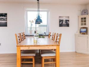 a dining room with a wooden table and chairs at 4 star holiday home in Ulfborg in Ulfborg +38 photos