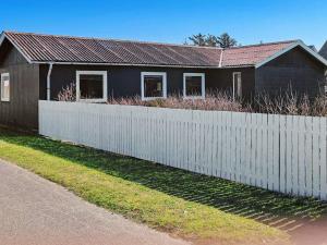 a house with a white fence in front of it at Luxury Spa Retreat in Thorsminde - By Traum Ferienwohnungen in Ulfborg