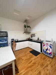 a kitchen with a stove and a sink and a table at Hoa dalathouse in Da Thanh