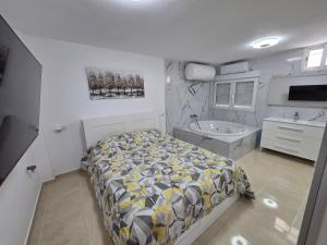 a bedroom with a bed and a sink and a tub at Lagoon Suits in San Borondón +70 photos